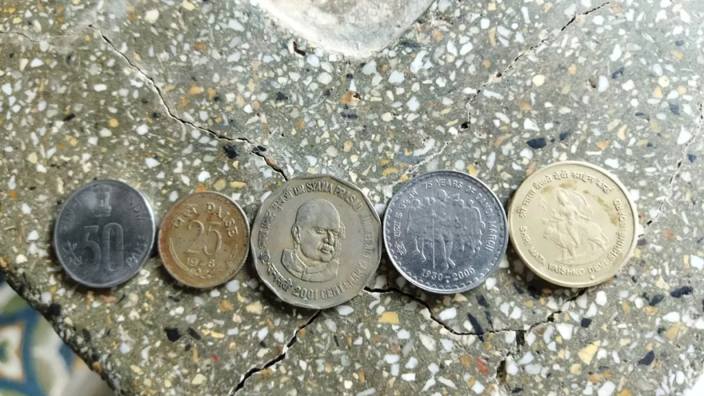 Five Indian coins of different denominations placed in a row